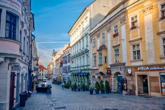 Bratislava, Slovakia &ndash; July 24, 2025: Atmospheric street scenes in Bratislava&rsquo;s historic city center, featuring narrow cobblestone alleys
