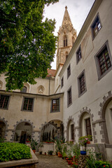 Bratislava, Slovakia – July 24, 2025: Narrow cobblestone alley lined with restored historic buildings in Bratislava’s Old Town, featuring colorful façades, and ornate doors.
