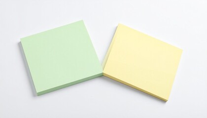 Two blank sticky notes, green and yellow, on a white background, ideal for reminders, messages, or office supplies concepts.