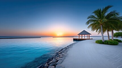 Tropical beach cabana at sunset with white sand and palm trees reflecting on calm blue water during golden hour
