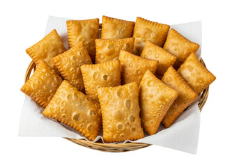 A light brown woven basket filled with numerous golden-fried pastries empanadas, white background isolated