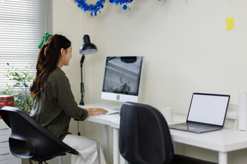 Freelance lifestyles working at home office concept. Asian woman using computer productive time...