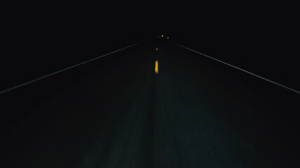 POV in the car, driving on a dark empty road, highway in the middle of the night