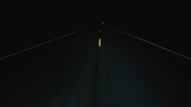 POV in the car, driving on a dark empty road, highway in the middle of the night