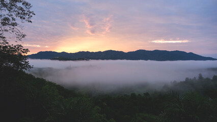 Landscape image of mountains peak and sky with the sea of clouds before sunrise