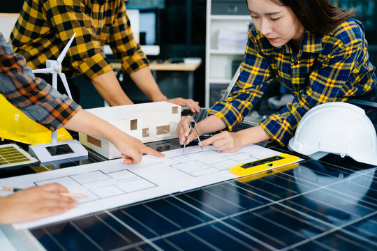 Creative architect projecting on the big drawings with architectural project at construction site at desk in modern office