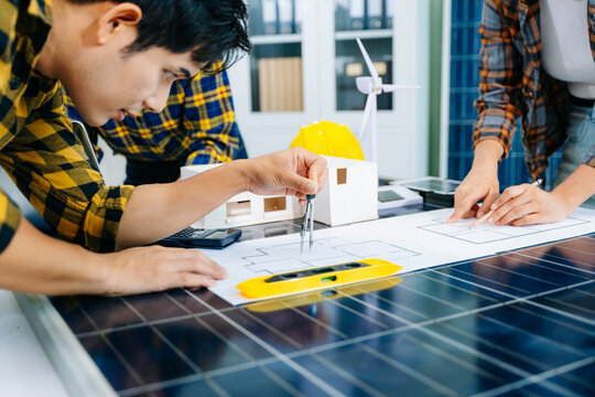 Creative architect projecting on the big drawings with architectural project at construction site at desk in modern office