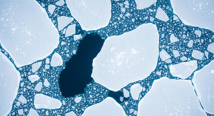 High angle aerial view of arctic ice floes, fragments, and open water in deep blue sea.