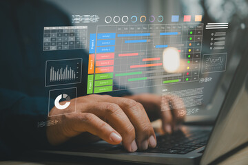 Businessman using laptop with project management dashboard showing schedule, chart, and data visualization representing workflow planning, task tracking, and business performance analytics concept.