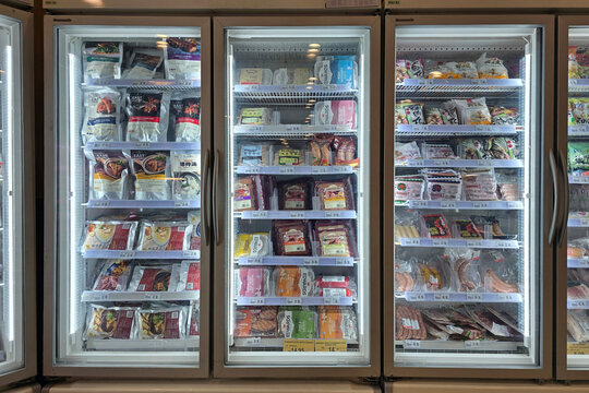 Kuala Lumpur, Malaysia &ndash; Sep 14, 2025: A brightly lit frozen food section inside Jaya Grocer featuring multiple glass-door freezers stocked with various frozen products.