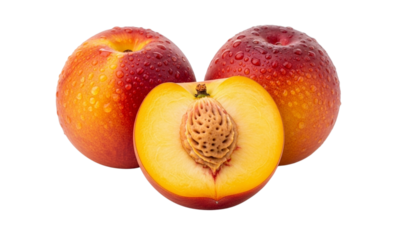 Close-up shot of three ripe peaches, one sliced open to reveal the pit.