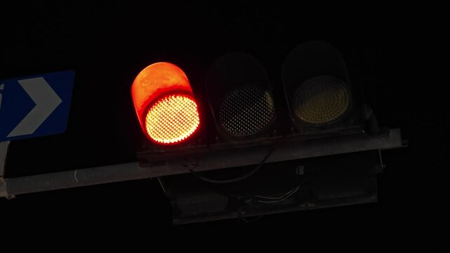 Red, yellow and green traffic lights in city. Flashing and changing color from red to green.
