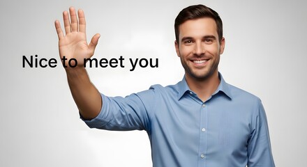 A friendly young man with a bright smile and casual attire greets with an open hand gesture in a professional setting, conveying warmth and approachability