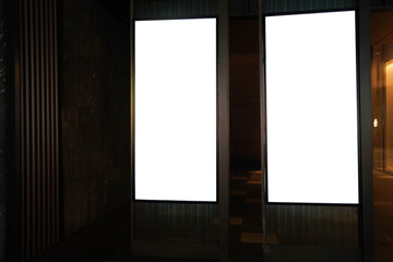 Street advertising mockup template with copy space. Two outdoor commercial banners with white empty display on the night street