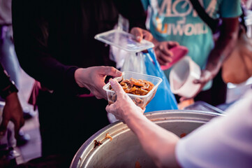 Volunteers are giving food to the homeless poor, Free distribution of food to the poor in today's society