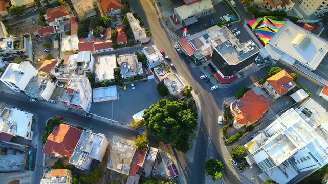 Aerial panoramic view of Limassol, Cyprus, highlighting the modern skyline, residential areas, and green spaces. The image captures the vibrant city life, urban development.