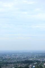 Fototapeta premium Panoramic City View with Lush Green Hills