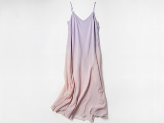 An ethereal, overhead photograph of a flowing, floor-length silk slip dress in a pale pastel color