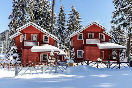Red wooden houses covered with snow in winter season located in Borovets village - Bulgaria.