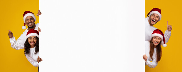 A group of five friends is joyfully posing with thumbs up, wearing Santa hats and white shirts in front of a bright yellow background. They seem excited to share messages.