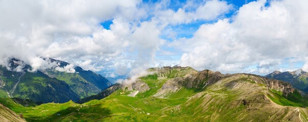 Discover the stunning Alps with panoramic views of majestic mountains and vibrant meadows under a...