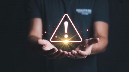 Urgent warning alert symbol glowing brightly over open hands, symbolizing critical danger or important notification for business safety