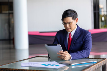 Young professional embraces digital business transformation, using tablet technology to drive...