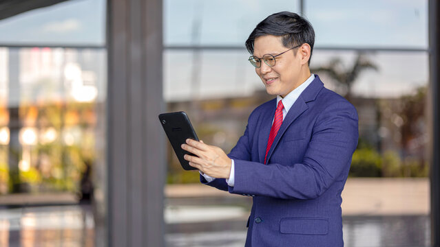 Young professional embraces digital business transformation, using tablet technology to drive innovation, next-generation solutions, and future-focused leadership in a modern workplace.