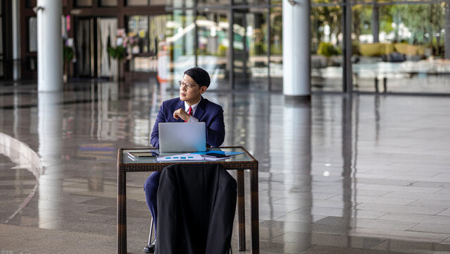 Young professional embraces digital business transformation, using tablet technology to drive innovation, next-generation solutions, and future-focused leadership in a modern workplace.