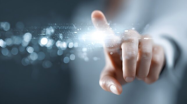 Glowing light emanates from a human finger, depicting digital interaction and technology.