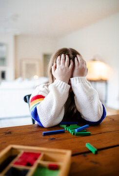 Young preteen girl covering her face with her hands frustrated
