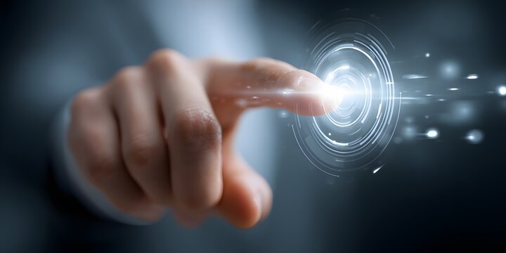 Human hand with a finger pointing towards the center of concentric circles emitting bright light and energy, depicting a futuristic or technological concept, all set against a blurry, dark backdrop.