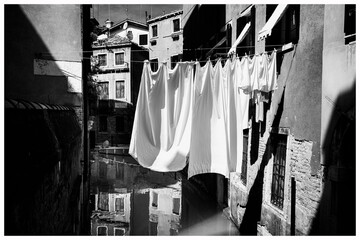 Venice - traditional laundry drying on a line over a canal