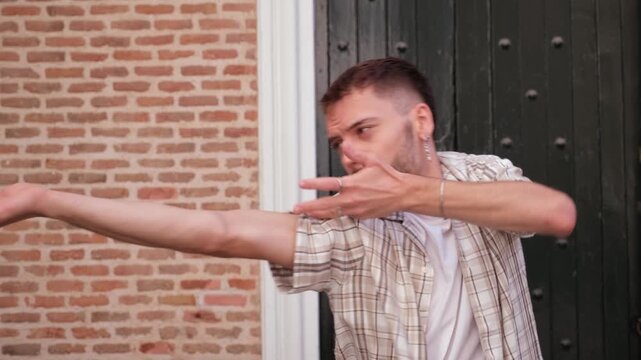 Contemporary dancer performing energetic and fluid freestyle waacking arm movements outdoors