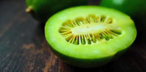 Melon Bitter Close up of a halved bitter melon with vibrant green flesh and seeds, dewdrops on its rough skin. Extreme close up macro shot of a halved bitter melon, revealing its vibrant green,
