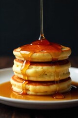 Artful Stack of Golden Brown Pancakes with Syrup Drizzle A precise, artful stack of three thick, golden brown, fluffy pancakes. A slow, viscous stream of rich, amber maple syrup is artfully drizzled