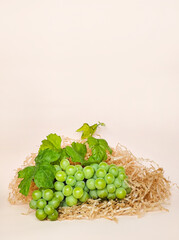 Green grapes on a beige background, composition