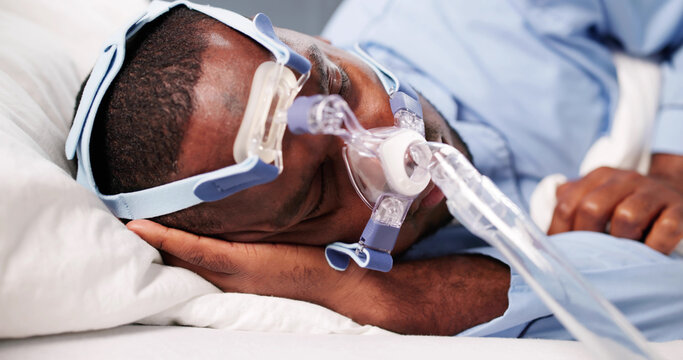 Man Using CPAP Mask For Sleep Apnea Therapy
