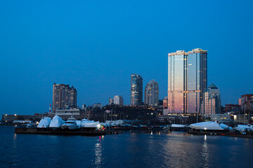 Evening Vladivostok. Embankment at sunset. A beautiful city by the sea.