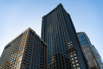 Fototapeta premium City architecture. Modern glass building. Reflective glass architecture. Architecture in business district. Building architecture. Business building. Glass building. Business city. Office center