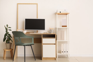 Comfortable workplace with computer in interior of office