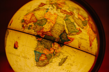 Close-up of an illuminated world globe focused on the Arabian Sea, India, and the Middle East, symbolizing trade, history, and geographical study
