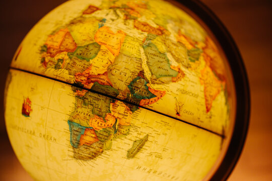 Close-up of an illuminated world globe focused on the Arabian Sea, India, and the Middle East, symbolizing trade, history, and geographical study