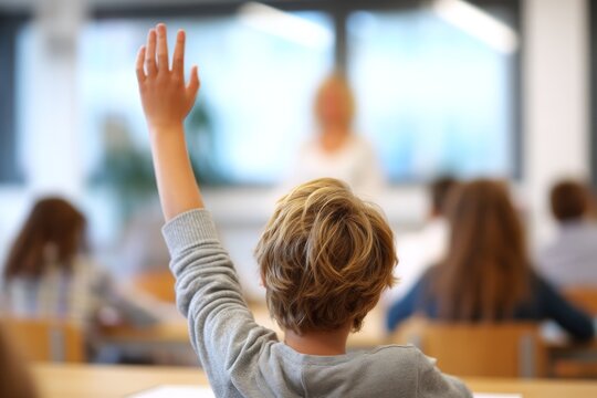 Student raising hand in a classroom