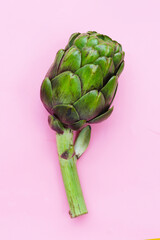 Fototapeta premium Purple artichoke on pink background.