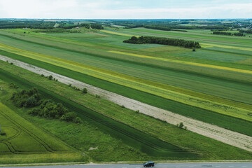 Obraz premium Drone view of peaceful rural farmland and crop field