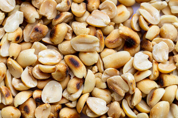 Close-up macro of roasted peanut texture,Close-Up of Shiny Roasted Peanuts Showing Texture and Perfect Crispness.