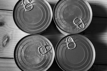 Monochrome image, thin canned food products close up shot, easy storage, quick warm meal preparation.