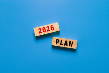 2026 plan text symbol on wooden blocks isolated on blue background
