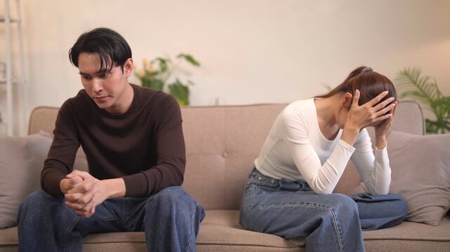 Asian adult couple experiencing relationship conflict stress sadness at home living room due to communication problems
